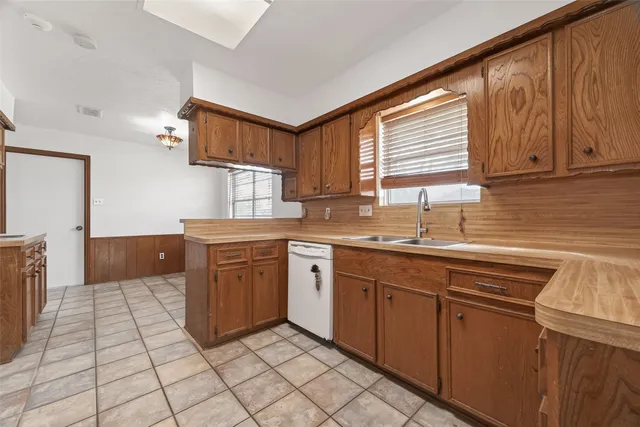 a kitchen with stainless steel appliances granite countertop a sink and cabinets