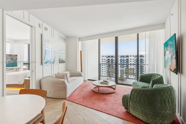 a living room with furniture and a floor to ceiling window