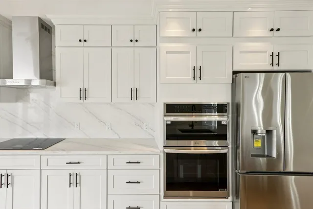 a kitchen with cabinets and stainless steel appliances