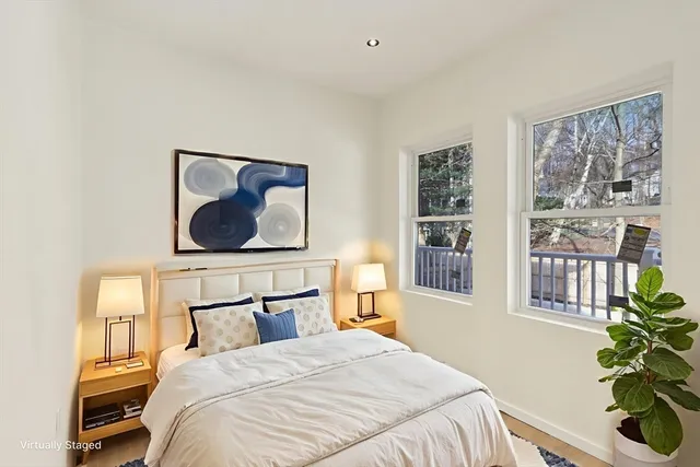 a bedroom with a bed and a painting on the wall