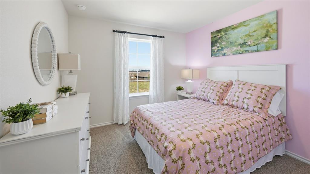 3435 Spur Run Sherman, TX 75090 - Photo 12 of 38 a bedroom with a bed and a potted plant