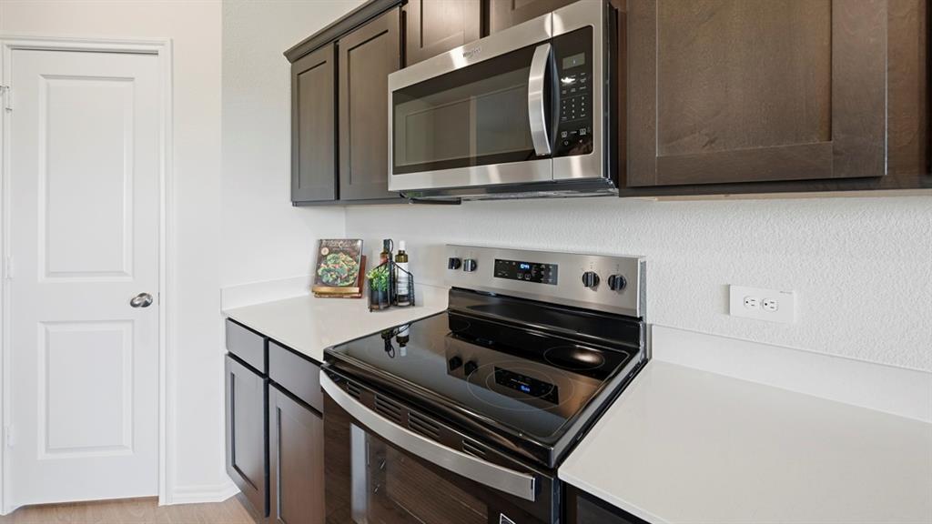 3435 Spur Run Sherman, TX 75090 - Photo 27 of 38 a kitchen with a stove and a microwave