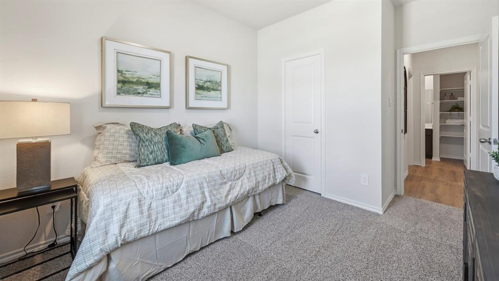 3435 Spur Run Sherman, TX 75090 - Photo 7 of 38 a large bed sitting in a bedroom next to a lamp