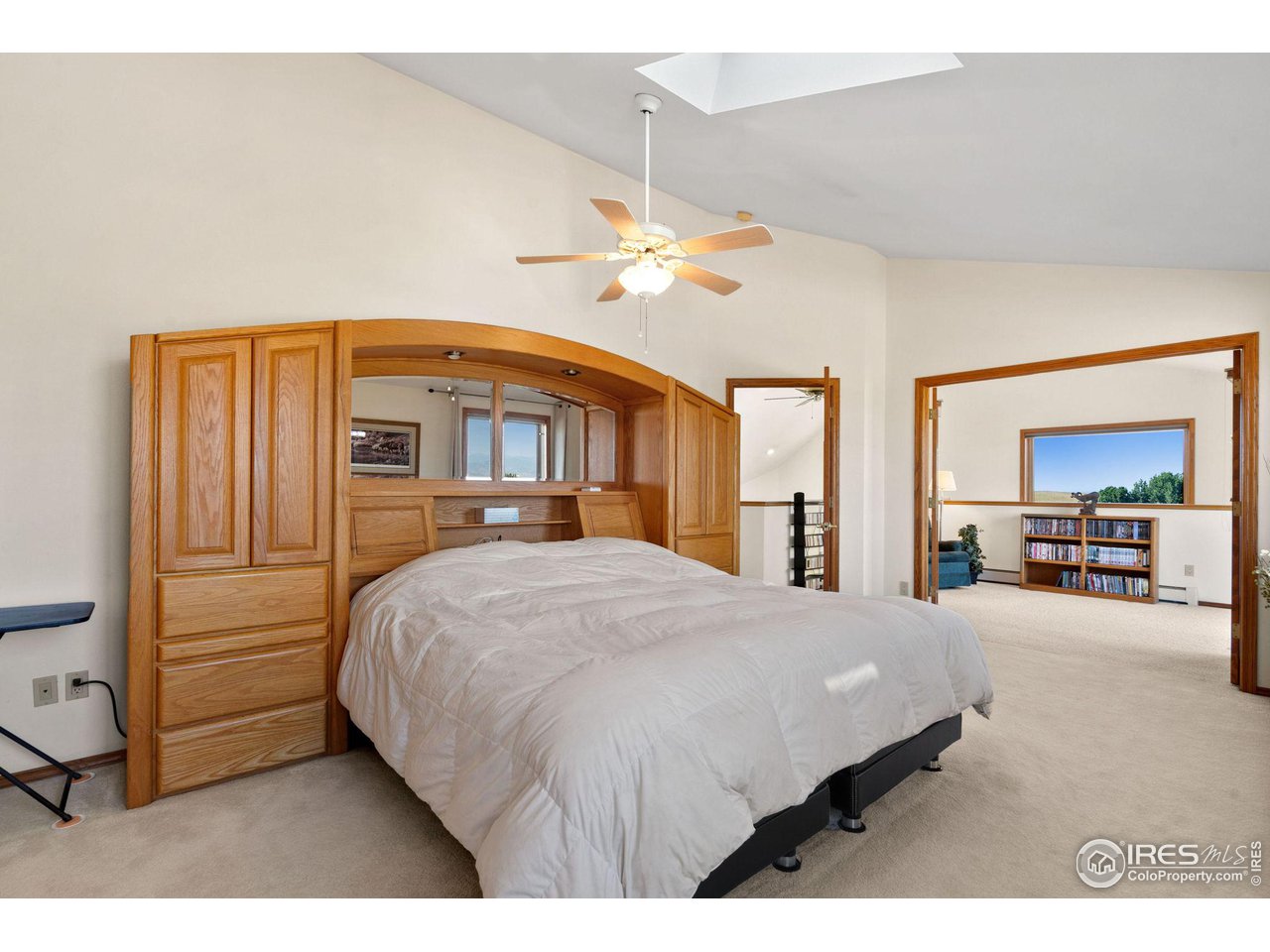 12492 Wasatch Road Longmont, CO 80504 - Photo 14 of 35 a bedroom with a bed dresser and a large window