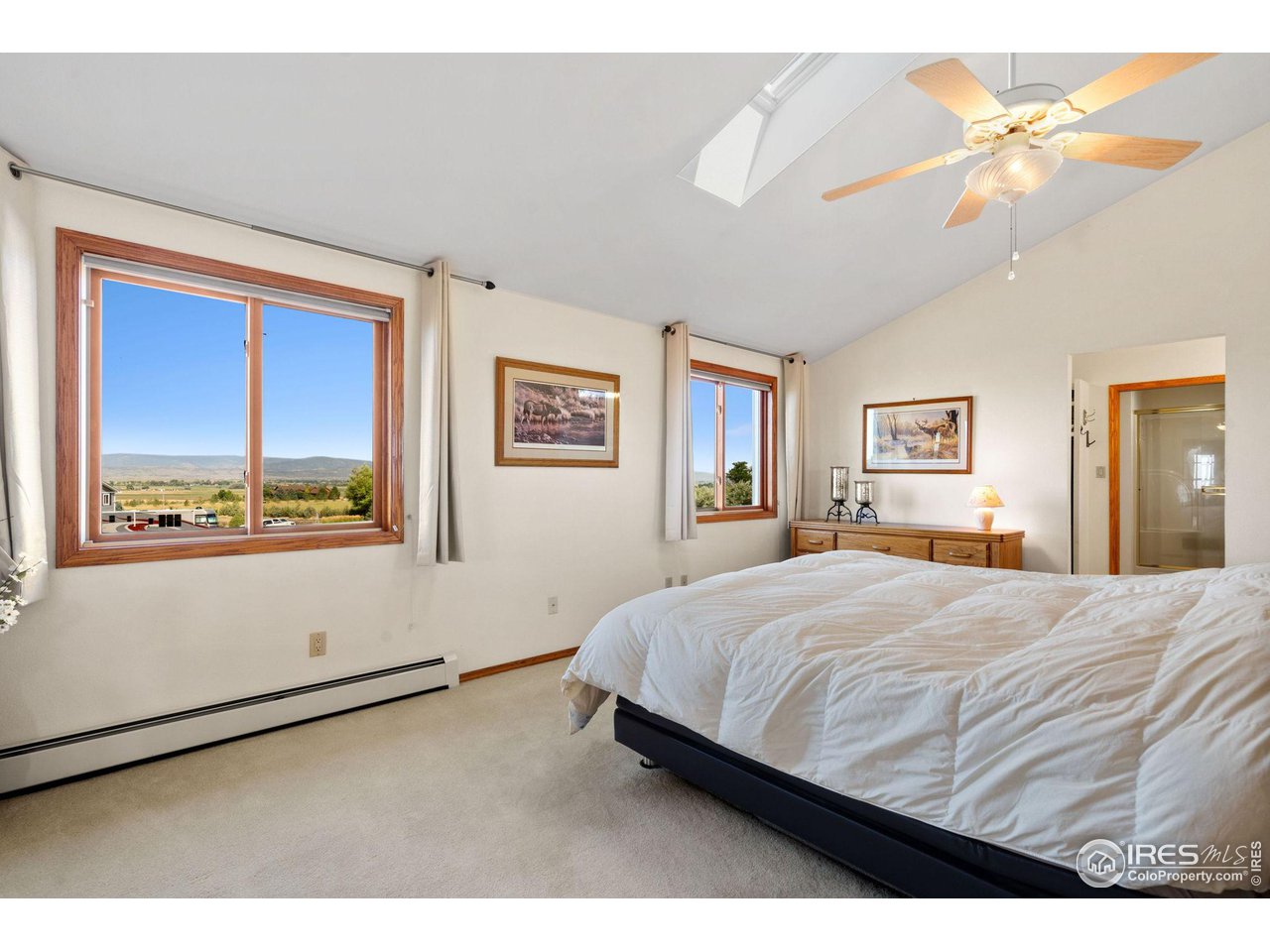 12492 Wasatch Road Longmont, CO 80504 - Photo 15 of 35 a bedroom with a bed and a painting on the wall
