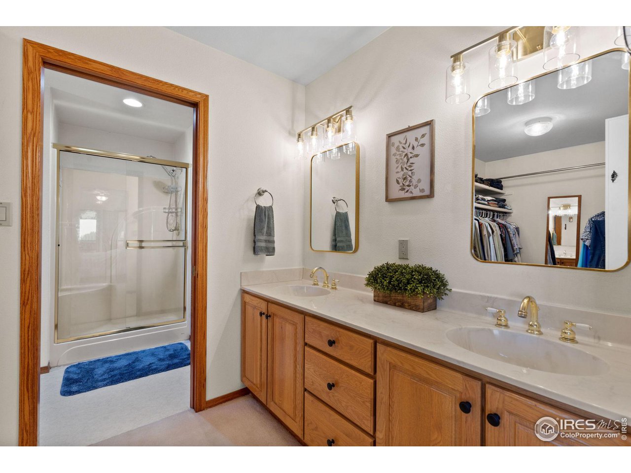 12492 Wasatch Road Longmont, CO 80504 - Photo 16 of 35 a bathroom with a granite countertop sink mirror and shower