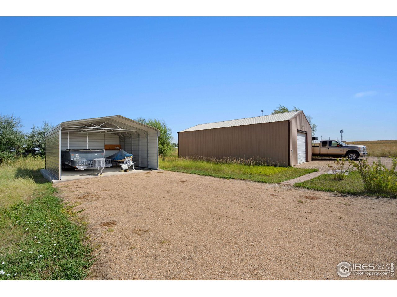 12492 Wasatch Road Longmont, CO 80504 - Photo 29 of 35 a car parked in front of a house with a yard
