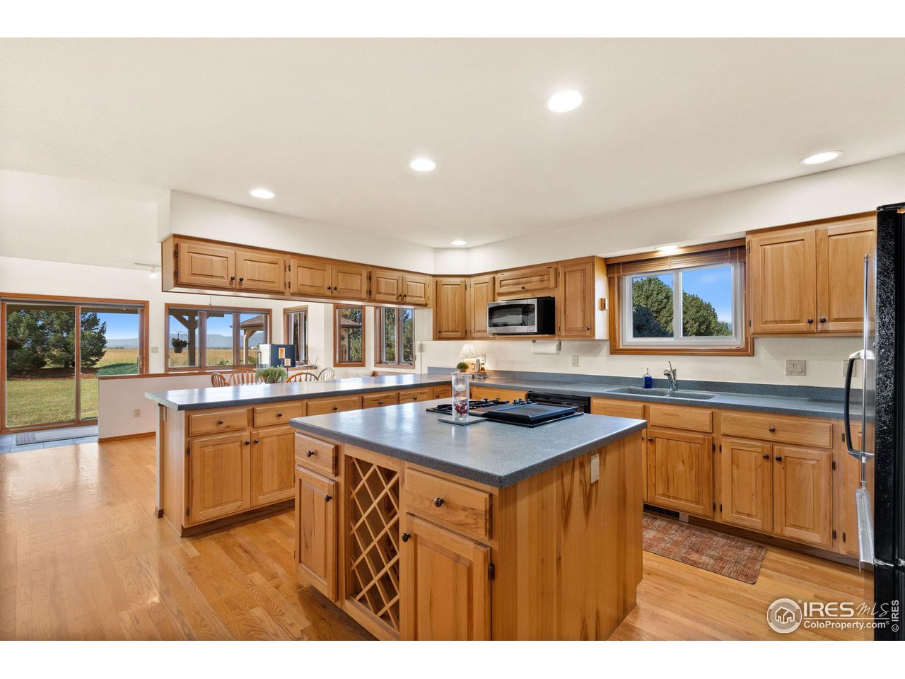 12492 Wasatch Road Longmont, CO 80504 - Photo 6 of 35 a kitchen with stainless steel appliances granite countertop a sink counter space and a stove top oven