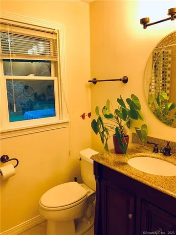 a bathroom with a sink mirror and toilet