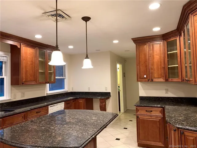 a kitchen with a stove a sink and a wooden floor