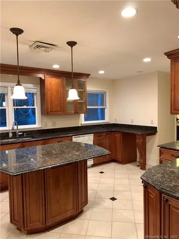 a kitchen with a stove a counter space and a sink