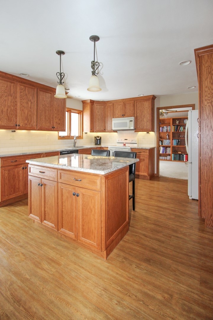 7417 East Maize Road Ridott, IL 61067 - Photo 11 of 46 a kitchen with stainless steel appliances granite countertop a sink counter space and cabinets
