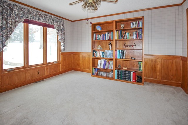 7417 East Maize Road Ridott, IL 61067 - Photo 15 of 46 an empty room with bookshelf and a large window