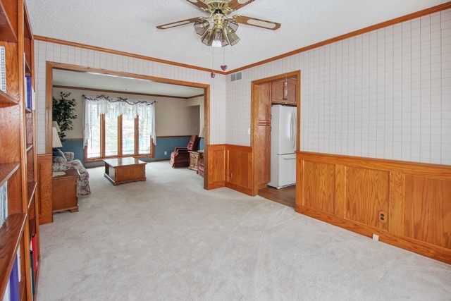 7417 East Maize Road Ridott, IL 61067 - Photo 18 of 46 a view of a livingroom with furniture and a ceiling fan