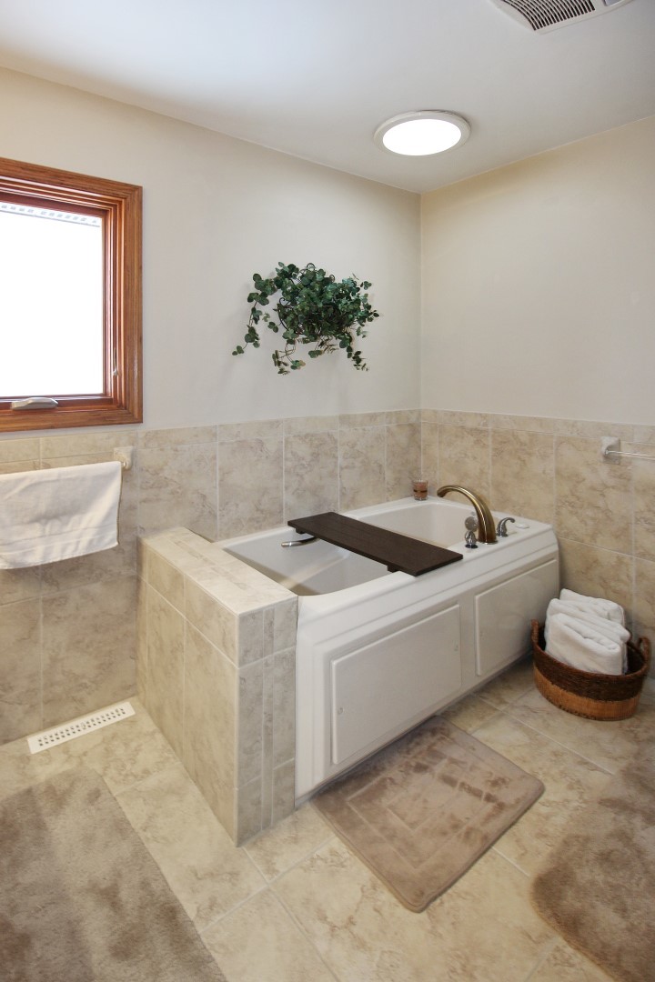 7417 East Maize Road Ridott, IL 61067 - Photo 27 of 46 a white bath tub sitting in a bathroom