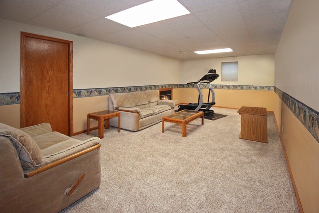 7417 East Maize Road Ridott, IL 61067 - Photo 34 of 46 a living room with furniture and a lamp