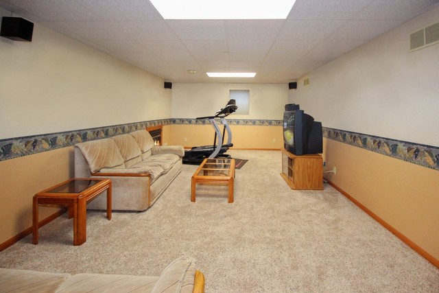 7417 East Maize Road Ridott, IL 61067 - Photo 35 of 46 a living room with couches and kitchen view with wooden floor
