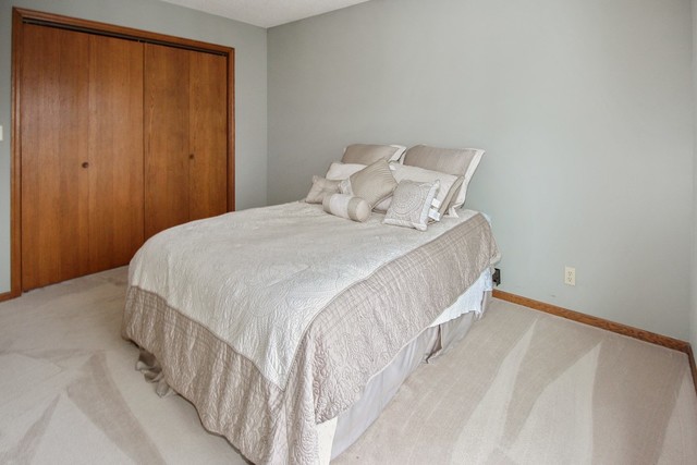 7417 East Maize Road Ridott, IL 61067 - Photo 39 of 46 a large white bed in a small room