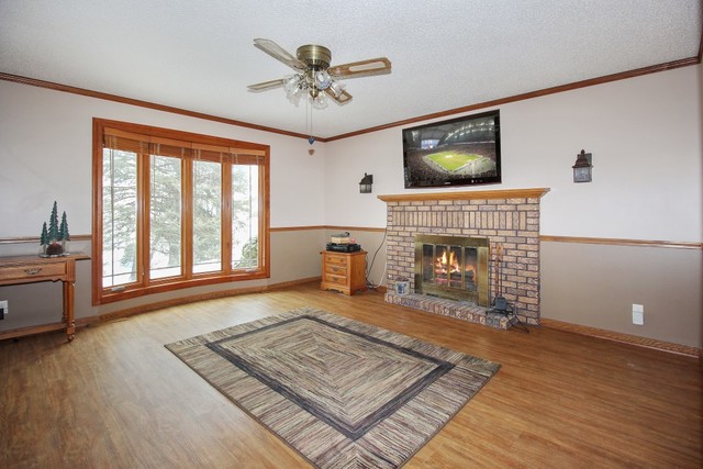 7417 East Maize Road Ridott, IL 61067 - Photo 6 of 46 a living room with furniture and a fireplace