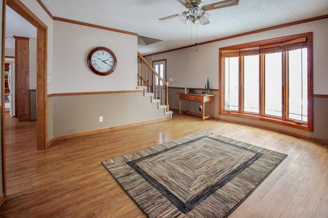 7417 East Maize Road Ridott, IL 61067 - Photo 8 of 46 a view of an empty room with a window and wooden floor