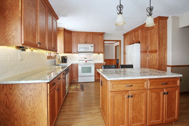 7417 East Maize Road Ridott, IL 61067 - Photo 9 of 46 a kitchen with a sink stove and cabinets