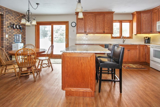 7417 East Maize Road Ridott, IL 61067 - Photo 10 of 46 a view of a dining room with furniture window and wooden floor
