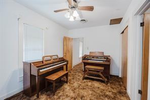 1717 Pipeline Road Cleburne, TX 76033 - Photo 10 of 33 Living area featuring carpet floors and a ceiling fan