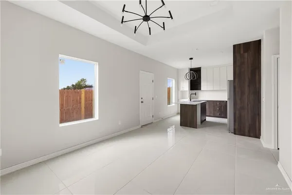 a view of kitchen with sink cabinets and window