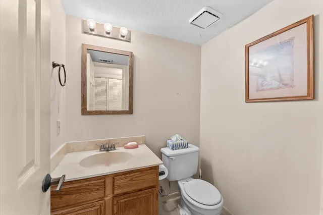 a bathroom with a sink toilet and mirror