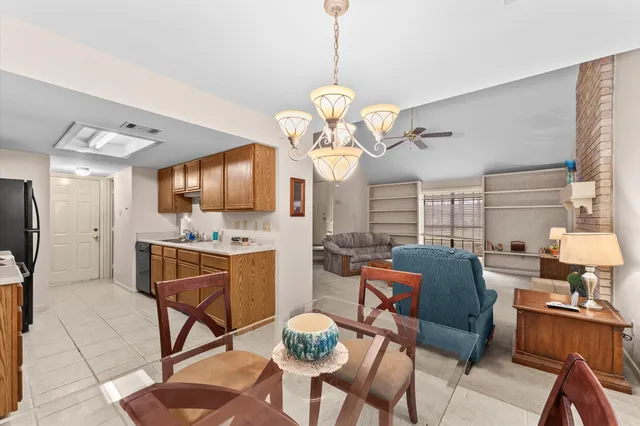 a view of a dining room with furniture and a chandelier