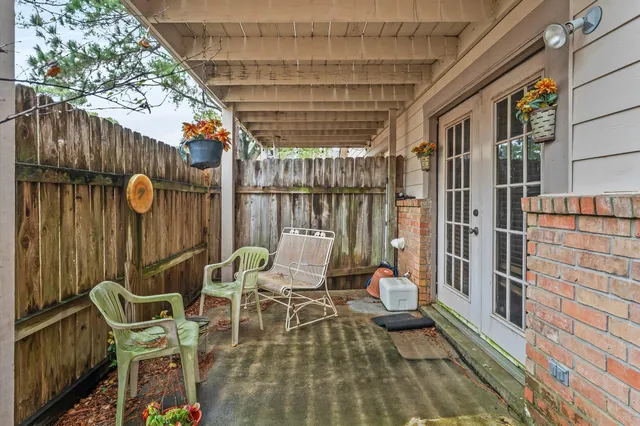 an aerial view of residential house with outdoor space and covered with trees
