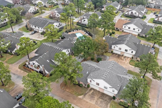 an aerial view of multiple houses with yard