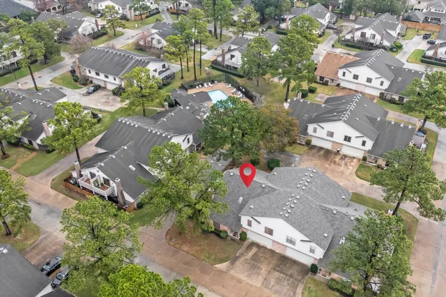 an aerial view of a house with garden space and a yard