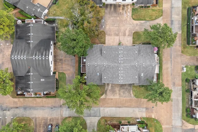 an aerial view of a house with outdoor space and swimming pool