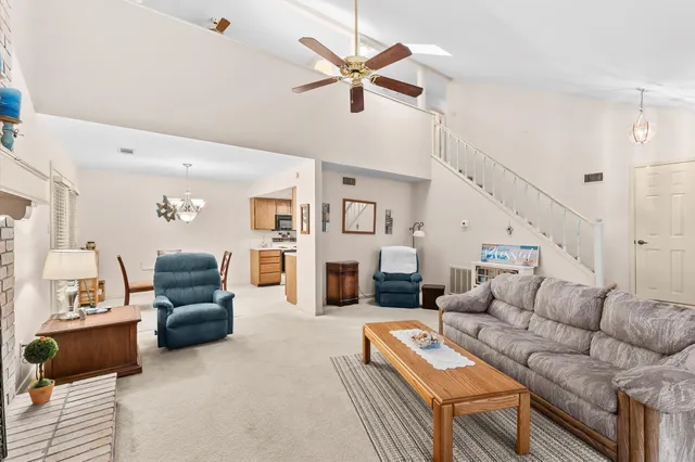 a living room with furniture kitchen view and a fireplace