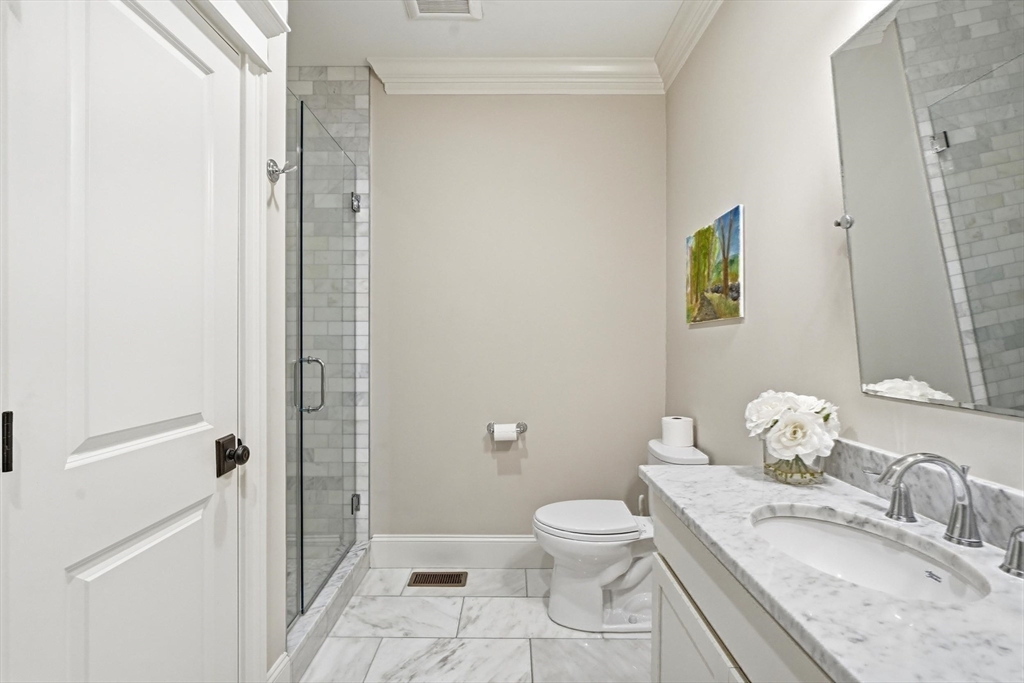 6 Flintlock Road Lexington, MA 02420 - Photo 18 of 39 a bathroom with a granite countertop sink toilet and shower