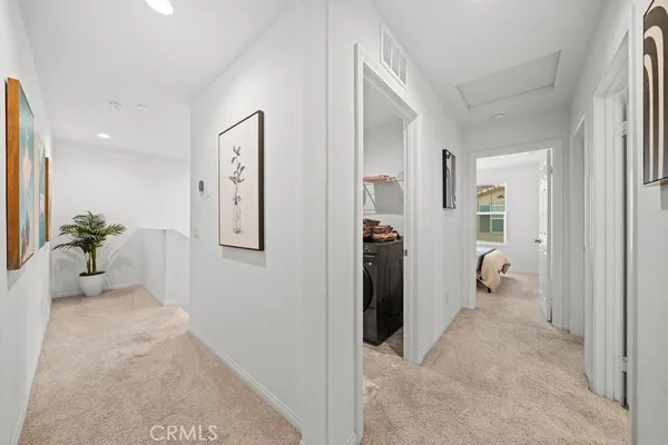a view of a hallway with bathroom and glass door