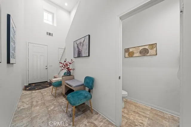 a living room with furniture and flowers