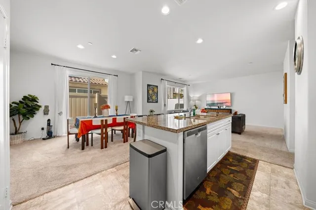 a kitchen with sink and lots of chairs