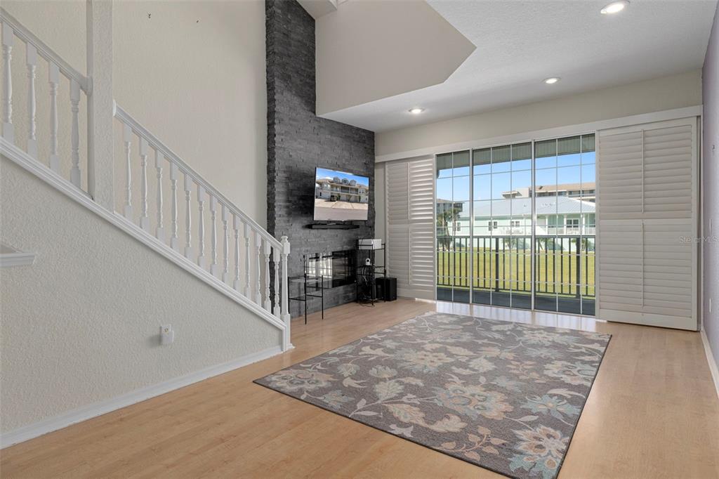 8304 Aquila Street Port Richey, FL 34668 - Photo 11 of 65 a view of a livingroom with wooden floor and a ceiling fan