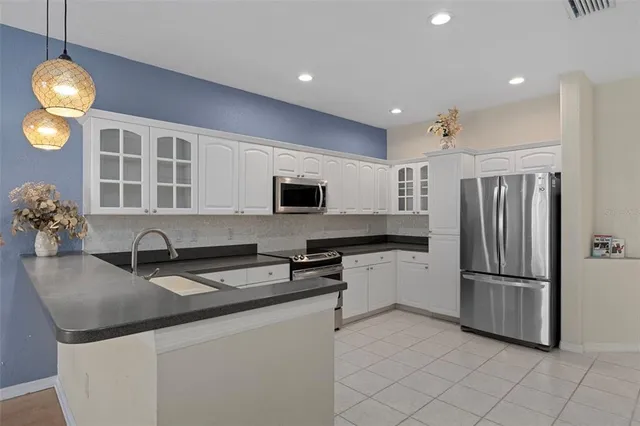 a kitchen with stainless steel appliances granite countertop a sink and a stove