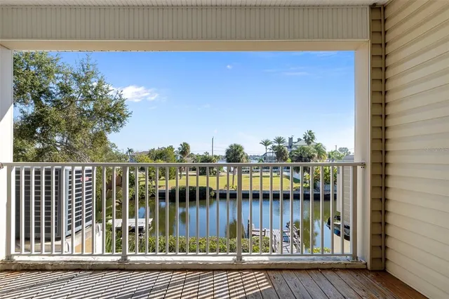 an empty room with windows and ceiling fan