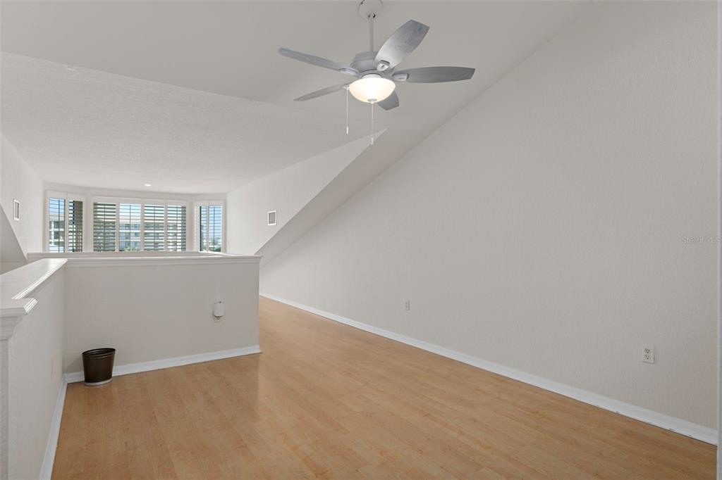 8304 Aquila Street Port Richey, FL 34668 - Photo 28 of 65 an empty room with windows and ceiling fan