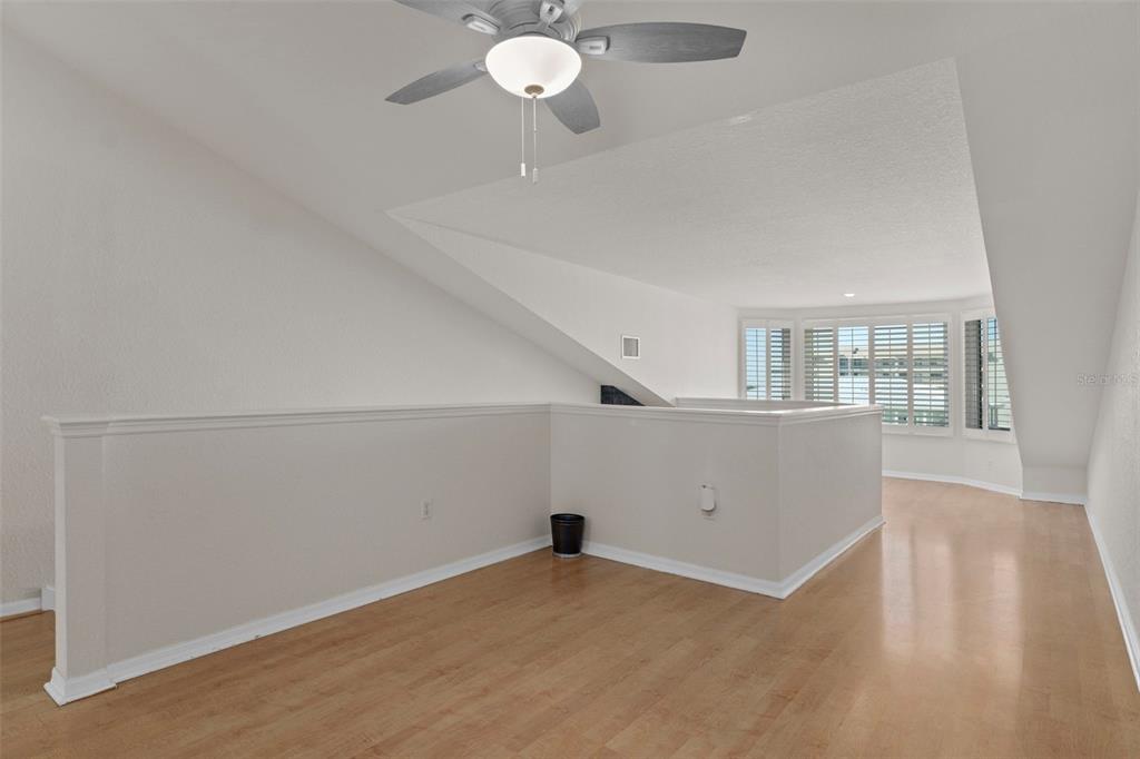 8304 Aquila Street Port Richey, FL 34668 - Photo 29 of 65 a view of an empty room with wooden floor and windows