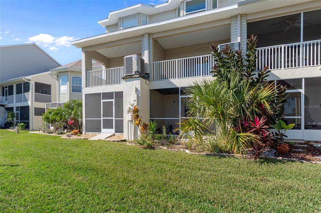 8304 Aquila Street Port Richey, FL 34668 - Photo 45 of 65 a view of a house with a yard and sitting area
