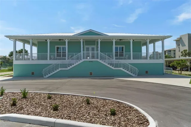 a front view of a building with table and chairs