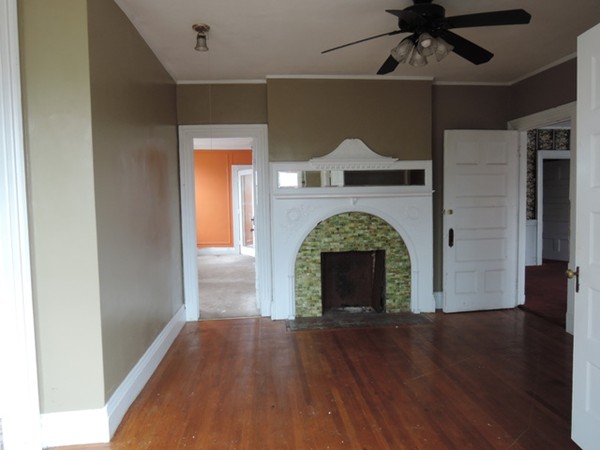 37 George Street Springfield, MA 01105 - Photo 15 of 28 a view of an empty room with wooden floor a fireplace and a window