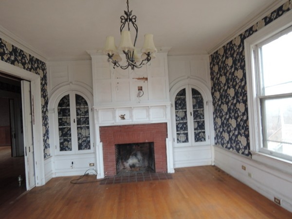 37 George Street Springfield, MA 01105 - Photo 7 of 28 a view of a livingroom with a fireplace a chandelier and windows