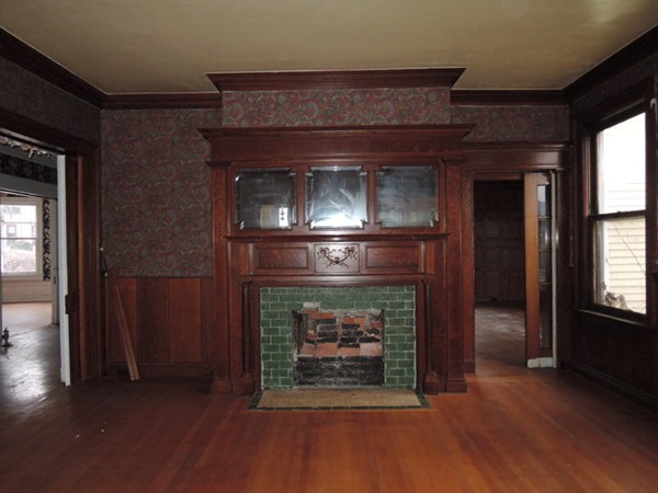 37 George Street Springfield, MA 01105 - Photo 9 of 28 a fireplace with a clock on top of it