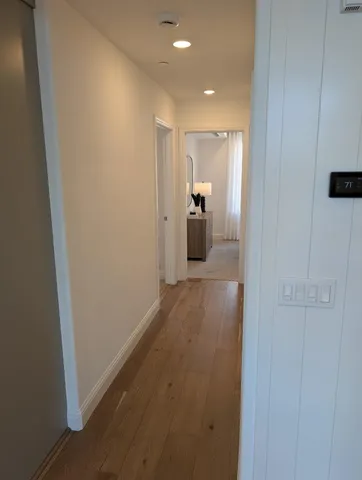 a view of a hallway with wooden floor